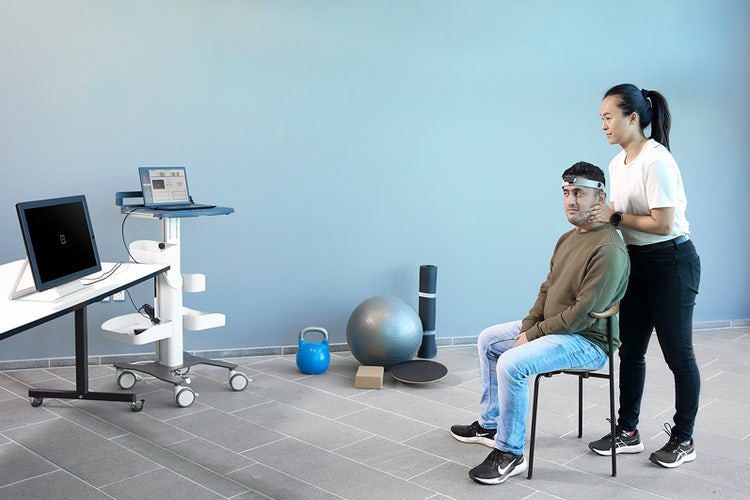 The patient is sitting a couple of meters away from a typical-sized computer monitor, which is displaying the optotype.