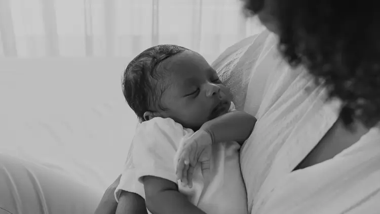 Clinician performing a newborn ABR hearing assessment