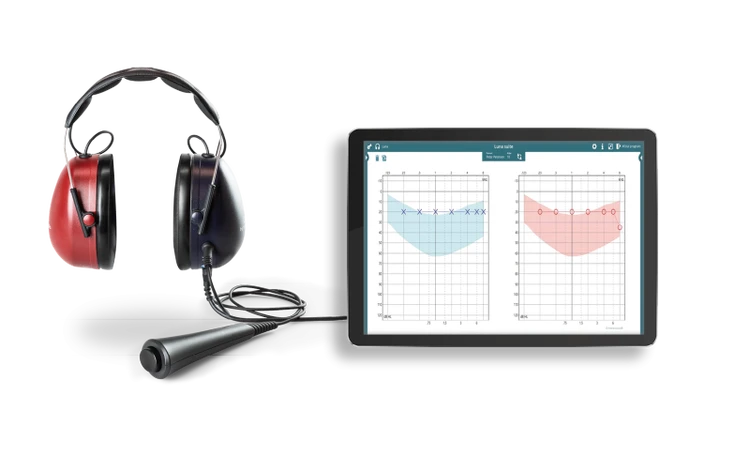 Luna audiometer, patient response button, and tablet showing audiograms