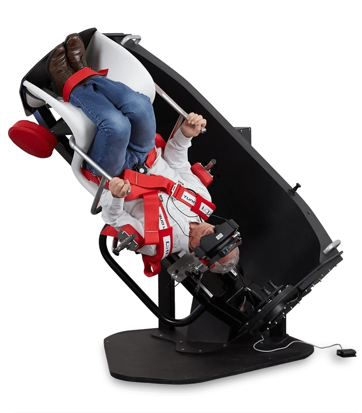 Man strapped into a TRV chair with his head facing downward