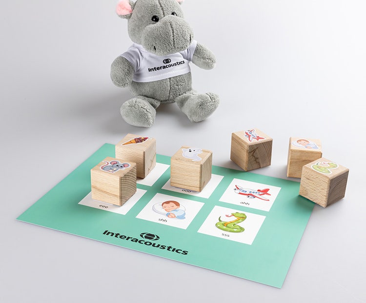 Each of the blocks depicts something associated with the given sound, with the mat having dedicated spaces for each of the blocks. For mmm, there is an ice cream. For ooo, there is a ghost. For ahh, there is a plane. For eee, there is a mouse. For shh, there is a child sleeping. And for sss, there is a snake.