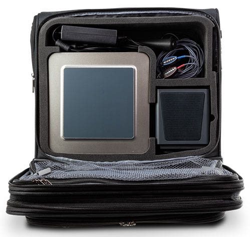 A view inside an open trolley bag. The Affinity Compact, a speaker, a patient response button and more fit neatly in separate compartments.