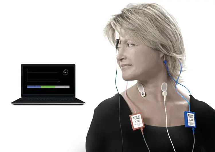 Female patient fitted with electrodes for VEMP testing