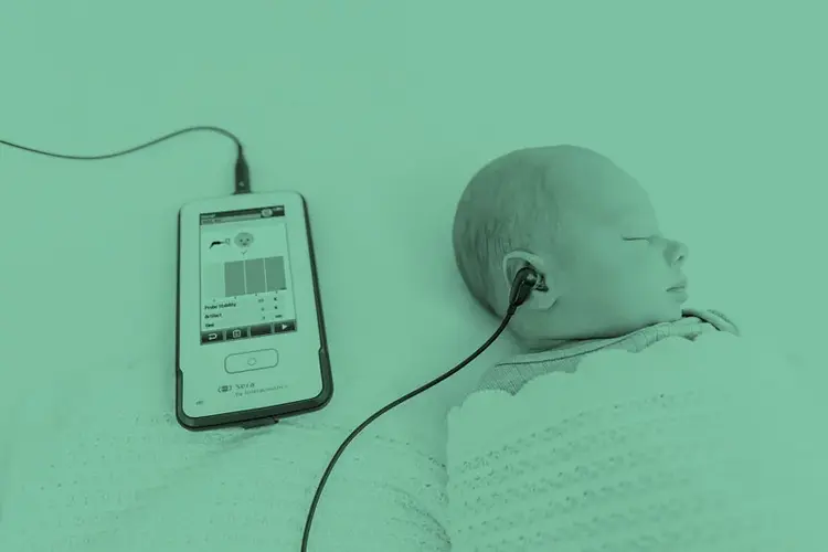 Sleeping baby with Sera SnapPROBE inserted into right ear