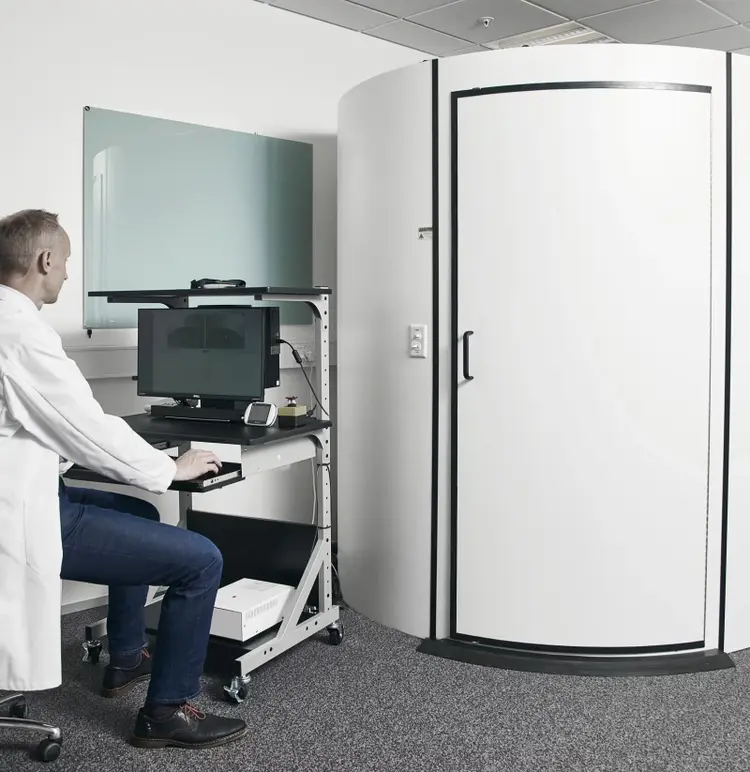 Male clinician observing rotary chair results screen