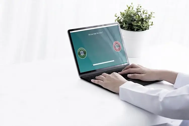 Clinician performing IA-AMTAS test on laptop