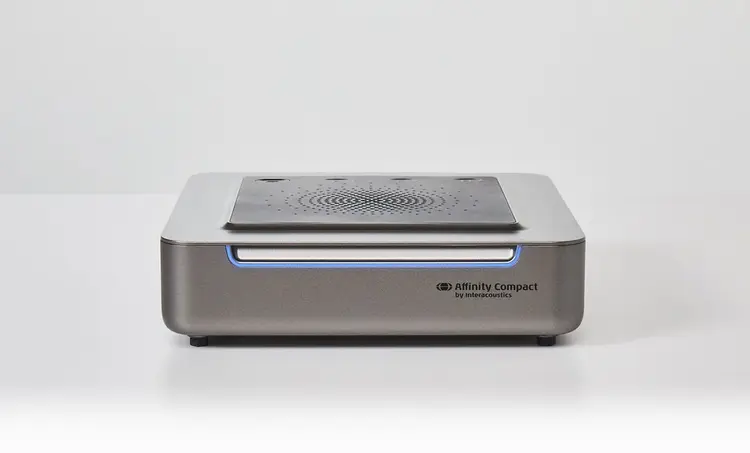 Version three of Affinity Compact. Speaker and plugs on its base. Blue light on the front of the unit.