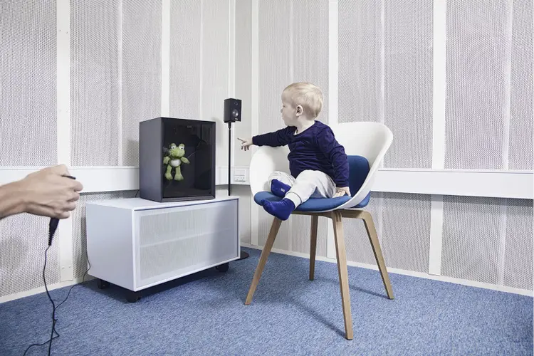 toddler pointing at animated toy frog located inside VRA201