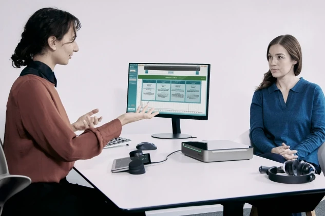 A clinician explaining Audible Contrast Threshold results to an adult patient