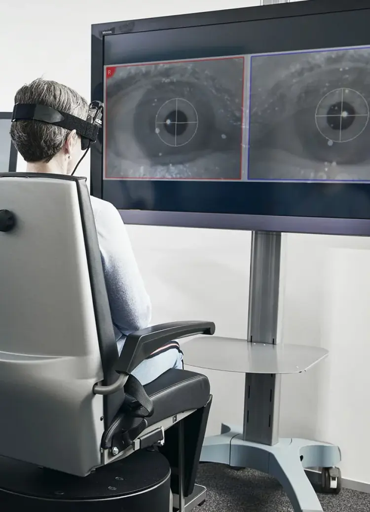 Female patient looking at eye recording with torsional analysis