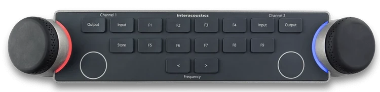 Audiometer Keyboard seen from above. There are two dials located on the left and right sides of the keyboard. The dials are encircled by LED lights which indicate different functions when in use. There are several keys between the multi-functional dials, which include and are not limited to input and output for channels one and two, store, two keys to decrease or increase the intensity, and nine F-keys labeled F1 to F9.
