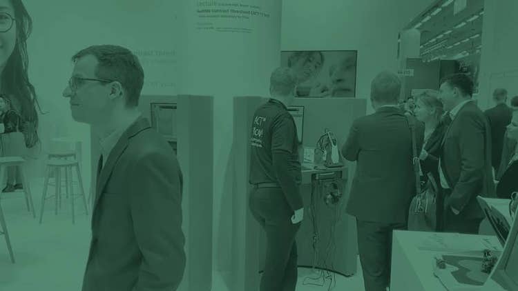 Visitors at the Interacoustics booth during a congress event