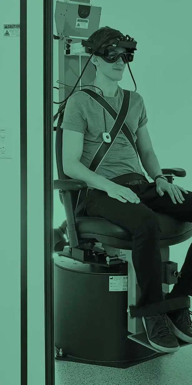 Patient seated in a rotary chair wearing video goggles for vestibular testing