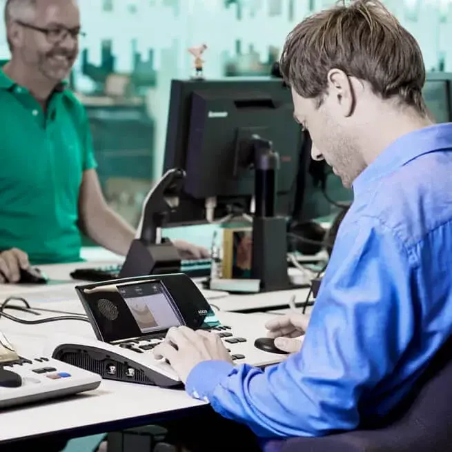 Employees working with an audiometer at a desk
