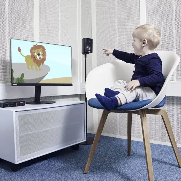 Young child responding to a screen during a pediatric audiometry session