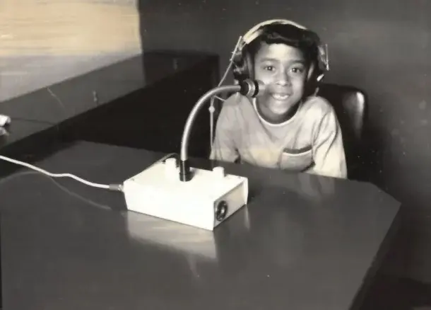 Black-and-white photo of a child wearing headphones during a hearing test