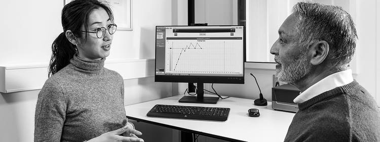 Two practitioners at the audiometry station during a hearing assessment