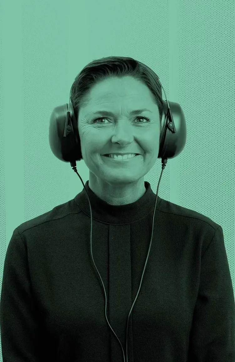 Patient smiling during an audiometric test, wearing circumaural headphones