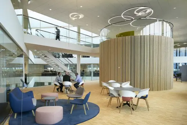 The open atrium with meeting areas inside the Interacoustics headquarters in Middelfart