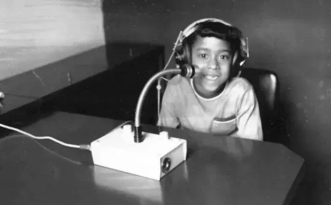 Archive photograph of a young boy wearing headphones during an early Interacoustics hearing test